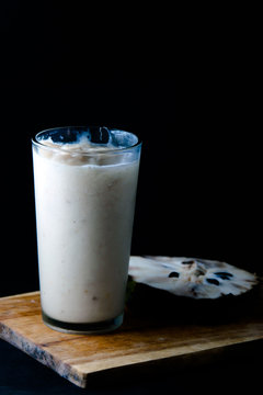 Sour sop juice in glass with black background