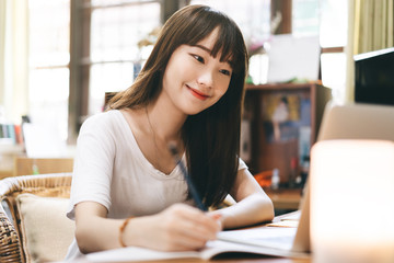 Asian teenager woman stay at home use internet for work and study
