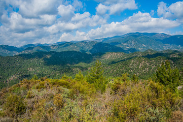 Light clouds cast fancy shadows on the peaks and slopes of the Troodos Mountains. Shadows creep from mountain to mountain, changing their shape.         