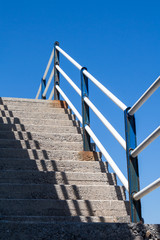 Stairs with a railing and a blue sky