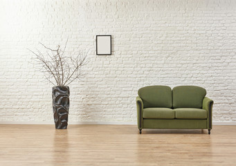 White living room concept, brick detail background and green armchair.