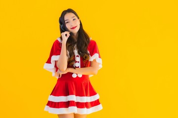 Portrait beautiful young asian woman wear christmas clothes and hat with headphone