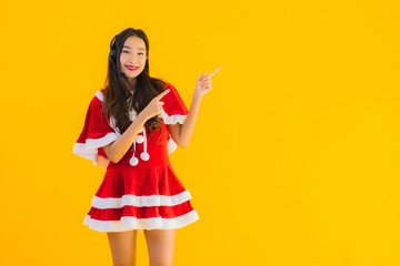 Portrait beautiful young asian woman wear christmas clothes and hat with headphone