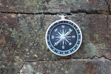 Fototapeta na wymiar Old compass on natural wooden background
