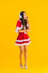 Portrait beautiful young asian christmas clothes and hat listen for music