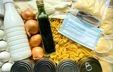 A large set of different food products, with a medical protective mask and antiseptic.