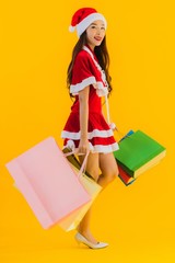 Portrait beautiful young asian woman wear christmas clothes hat with a lot of shopping bag