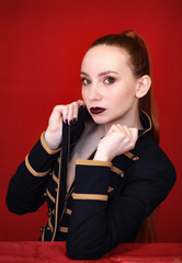 Concept portrait of red head girl on red background