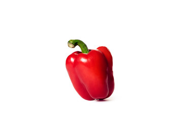 Red bell pepper stands on a white background. Bright color. Two light sources.