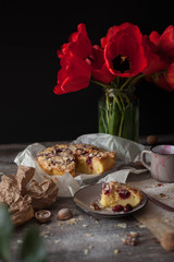 Still life with red tulips and a cherry pie. tasty and healthy food, homemade cakes