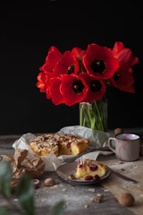Still life with red tulips and a cherry pie. tasty and healthy food, homemade cakes