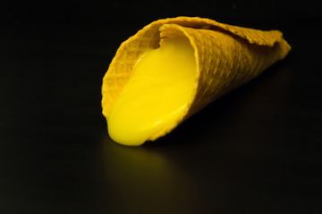 Wafer rolls with condensed milk on a white plate.
