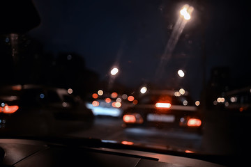 traffic of cars in the night city, view from the car, lights abstract auto background