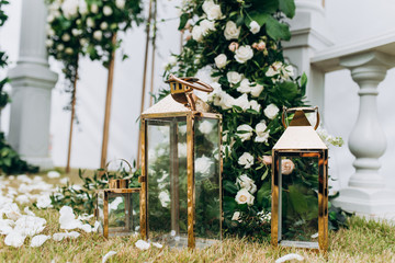 Glass lamps with candles at a wedding ceremony. Wedding decor at the ceremony.