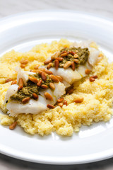 cod with green pesto and pine seeds with couscous