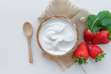 Yogurt in a bowl with spoons,Healthy breakfast with Fresh greek yogurt and strawberry on background