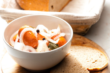 homemade pickled sausages with onion and bread