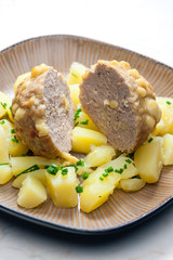 meat ball baked with beans and cheese served with potatoes