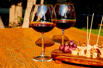 Glasses Of Fine Red Wine With Grape and cheese