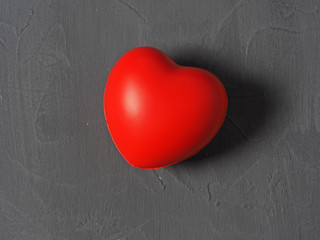 red heart on a gray background. Concept of love, health day, Valentine's day