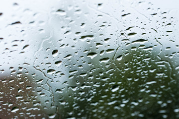 Rain drops on car windshield  close up macro shot on a spring day.