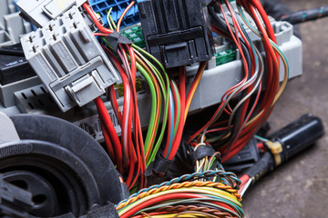Multi-colored electrical wires with connectors in the nodes of the car during network repair by an...