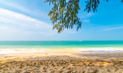 Fototapeta na wymiar View from tropical beach at Koh Lanta island, Thailand. View to pure sea with boats and yacht on water. Look from shadow of tree on sand beach. Summer paradise, vibrant colors, tropical exotic place