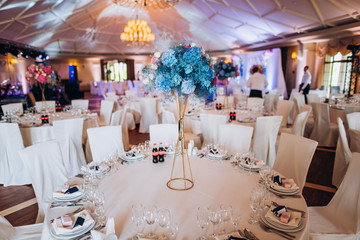 Beautiful flowers on table in wedding day. The white round banquet table in the restaurant is...