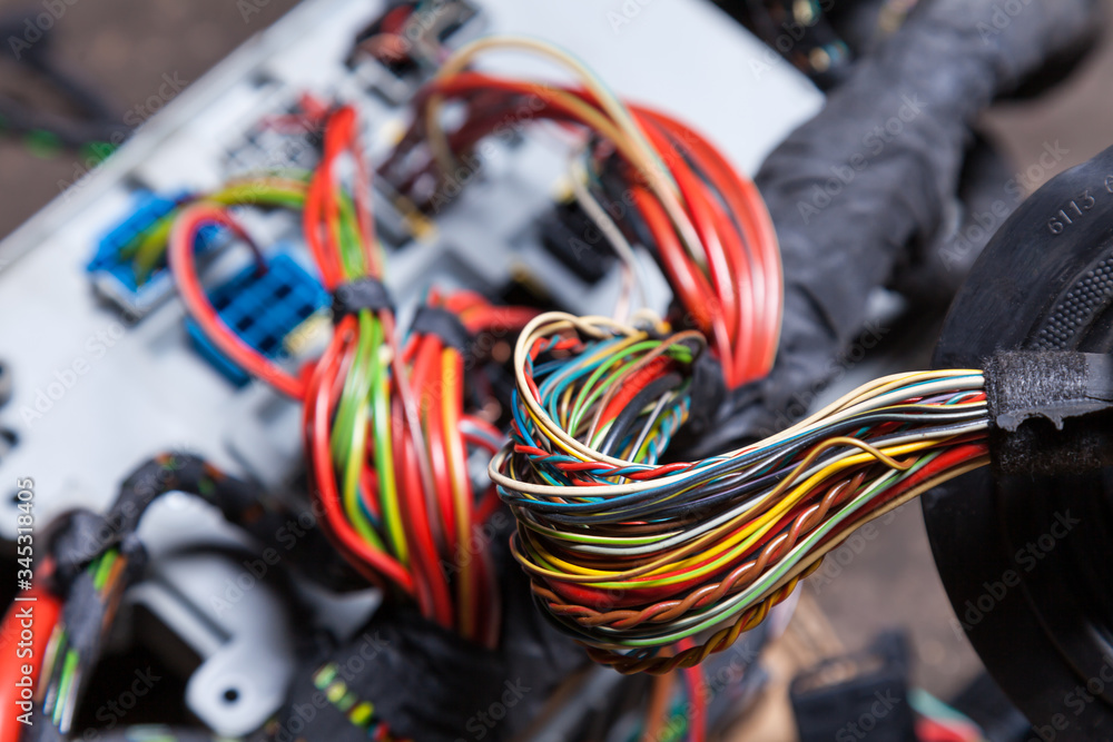 Canvas Prints Bunch of multi-colored electrical wires - blue, green, red and yellow, rewound with insulating tape leading to the connectors during network repair by an engineer or mechanic in a service or workshop