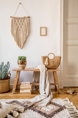 Stylish composition of living room interior with mock up frame, wooden bench, pillow, plaid, woman...