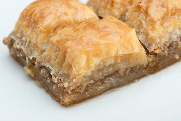 Turkish Ramadan Dessert Baklava isolated on beige plate.