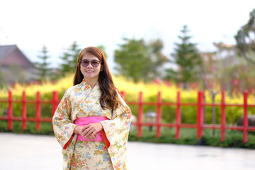 The girl wears a kimono and smiles happily.