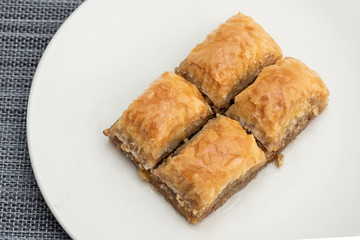 Turkish Ramadan Dessert Baklava isolated on beige plate.