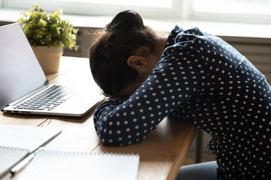 Side View Exhausted Millennial Teen Girl Student Dropped Head On Hands, Fall Asleep At Desk. Tired Young Indian Woman Napping At Workplace, Having Rest After Sleepless Night Exam Preparation At Home.