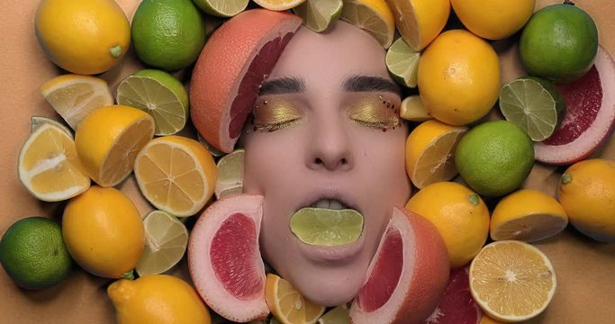 beautiful young woman with lemon and laim citrus. Beauty make up. High quality 4k video