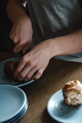 Young boy cutting a cake in half