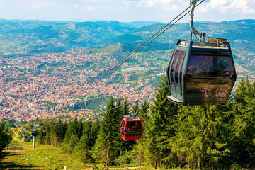 View from the top of the mountain on the city of Sarajevo and funiculars rising up to the highest...