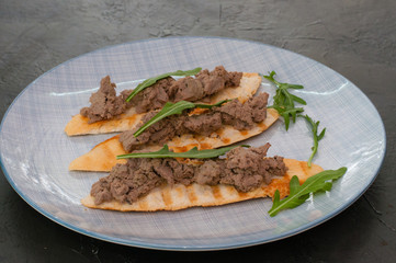 Croutons with paste and arugula. Festive appetizer, New Year's Italian dish. The view from top and there is room for text
