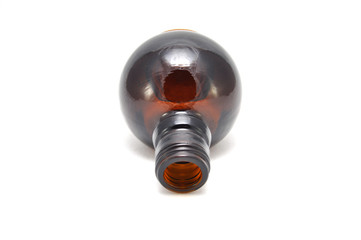Brown glass bottle on a white background close up