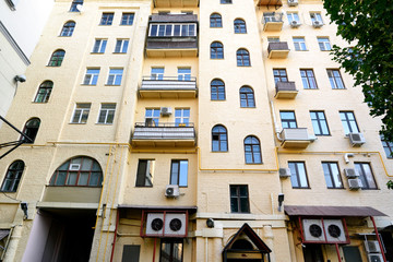 Multi-storey yellow residential building in center of Moscow. View from yard
