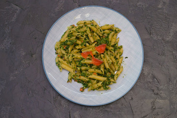 Delicious traditional Italian dish pasta with salmon, spinach and cheese.