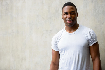 Portrait of happy young handsome African man smiling