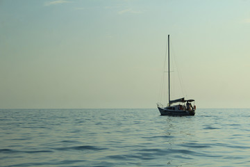 A lone boat floating on a calm sea. Tint