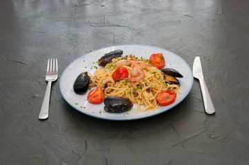 Spaghetti pasta with shrimp, mussels, tomatoes and cheese. Tasty, traditional Italian food