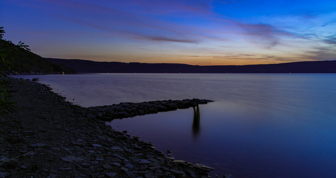 Mystic Concept Of Long Exposure Landscape Photography Scenic Shore Line Water Reservoir Fuzzy Water Motion And Abstract Human Silhouette Reflection Without Person In Photography Night Twilight