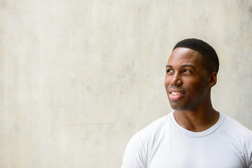 Obraz premium Face of happy young handsome African man thinking