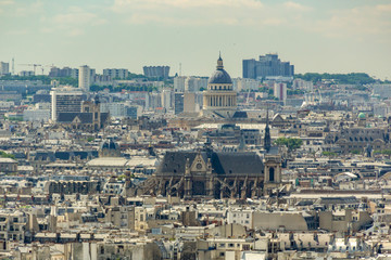 Naklejka premium PARIS, FRANCE - JUNE 23, 2016: Aerial view from Basilica of the Sacred Heart of Jesus stands at the summit of the butte Montmartre - highest point in the Paris. Telephoto lens shot