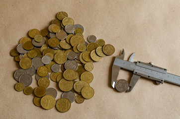 Ukrainian coins of different denominations randomly on the table.