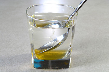 Mixing honey in water with the spoon