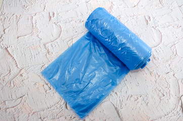 Blue roll of trash bags on the table.